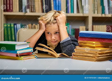 Boy Looking Bored While Studying At The Library Stock Image Image Of