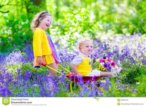 Kids In A Garden With Bluebell Flowers Stock Photo Image