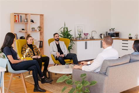 People Seated In Living Room Photo Free Person Image On Unsplash In