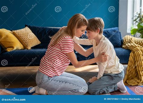 Mother And Son Touching Foreheads While Spending Time Together At Home