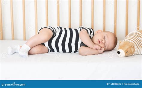 Adorable Newborn Baby Sleeping On His Side In Crib Stock Image Image