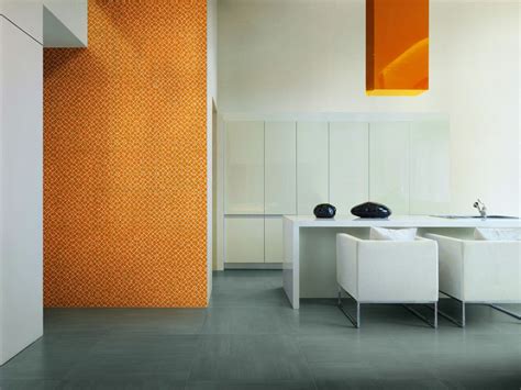 An Orange And White Room With Two Chairs In Front Of The Table One On