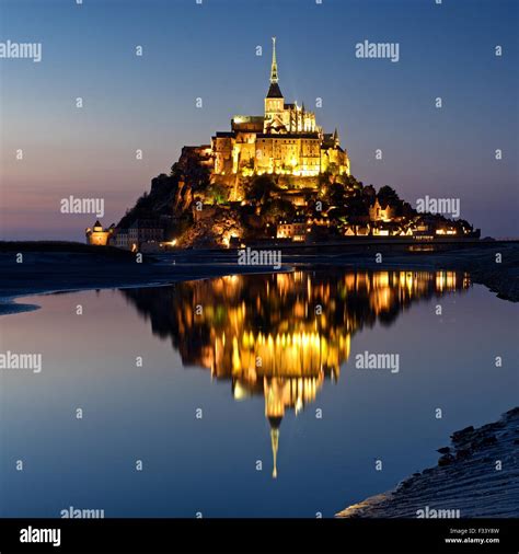 A Colour Image Of Reflections Of Mont Saint Michel Lit Up At Dusk In A