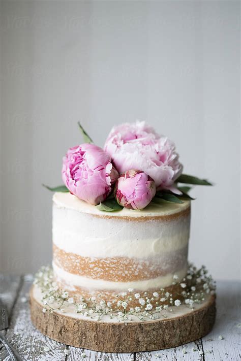 Naked Wedding Cake Decorated With Fresh Flowers By Stocksy Contributor Ruth Black Stocksy