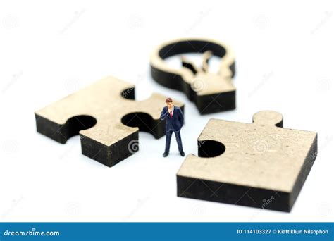 Miniature People Businessman Standing With Jigsaw Puzzle Piece Stock