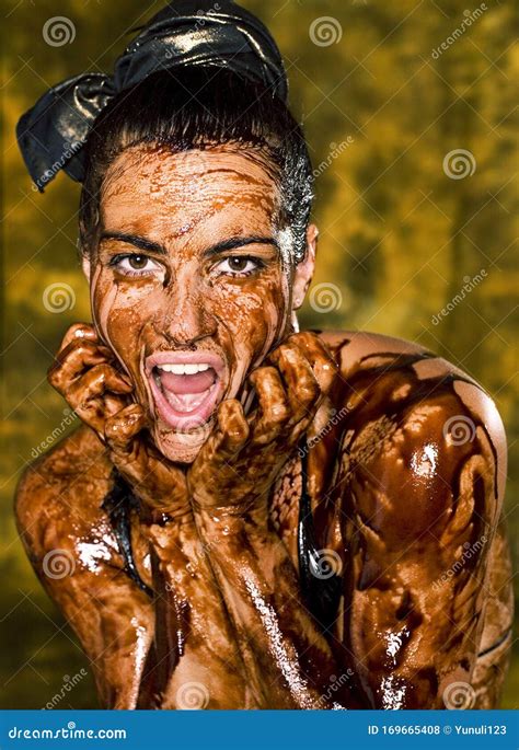 Young Brunette Girl On Bright Background Covered Chocolate Cream All