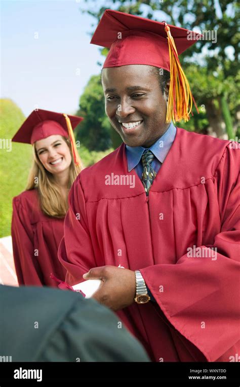 Graduate Shaking Hand And Receiving Diploma Stock Photo Alamy