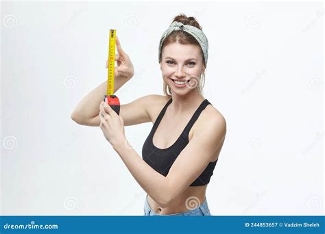 Beautiful Blonde Girl Holds A Measuring Tape In Her Hands Measurement Concept About Penis Size