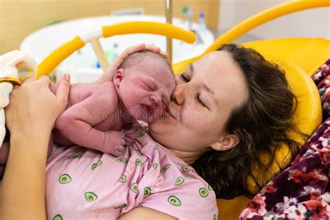 Newborn Baby On His Mothers Arms Right After Delivery Stock Image