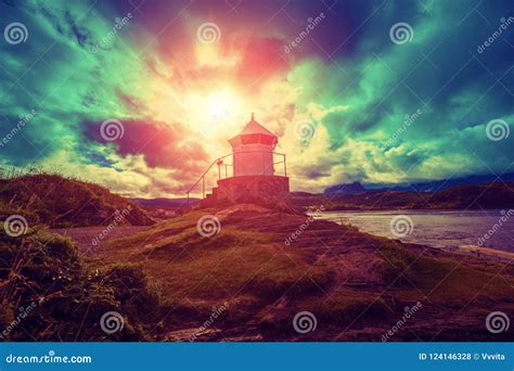 Lighthouse Against Dramatic Cloudy Sky During Sunset Stock Photo