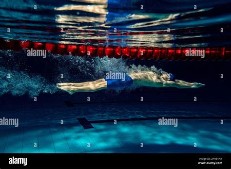 Professional Male Swimmer Training At Pool Indoors Underwater View Of