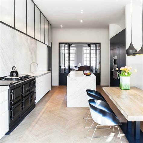 The island is the focal point along with wonderful lighting…a stunning floor and sleek lines…a touch of greenery and major style. 33 Inspired Black and White Kitchen Designs - Decoholic