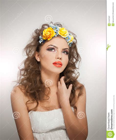 Portrait Of Beautiful Girl In Studio With Yellow Roses In