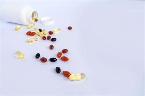 Premium Photo Colored Vitamins And Supplements On A White Background