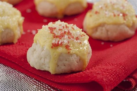 Cookie dough balls are coated in walnuts then filled with lemon curd. Mrs. Claus' Lemon Cookies | Lemon cookies, Dessert recipes ...