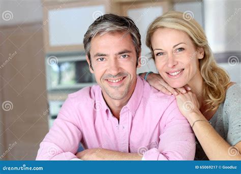 Cheerful Mature Couple Sitting In The Kitchen Stock Image Image Of Blond Affectionate 65069217