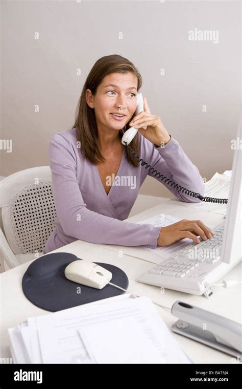 Studies Desk Woman Works Computers Telephones Smiles Semi Portrait
