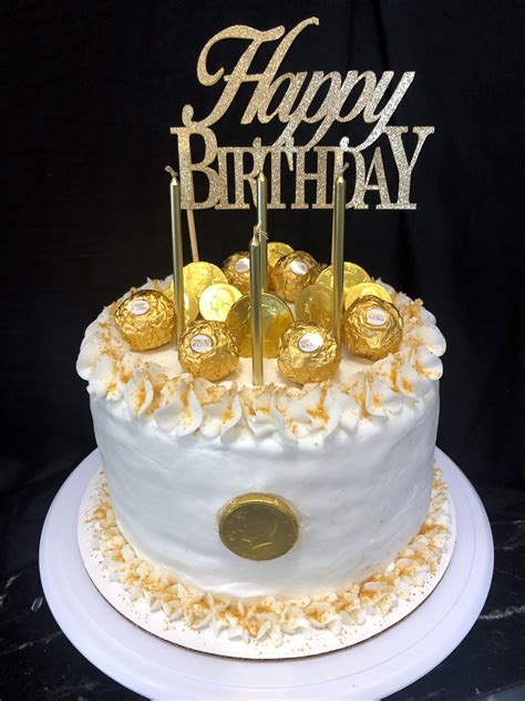 Gold Birthday Cake With Festive Decorations