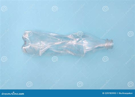 Empty Crumpled Plastic Bottle On A Blue Background Recycling Concept