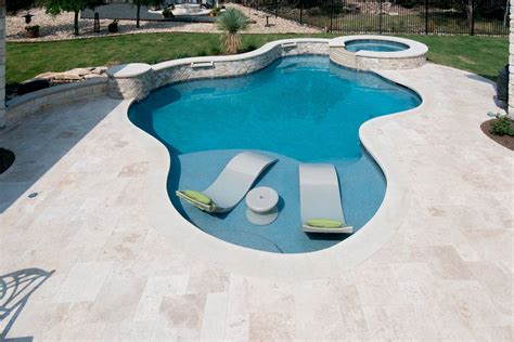 Travertine Deck With Lueder Coping Surrounding A Freeform Pool