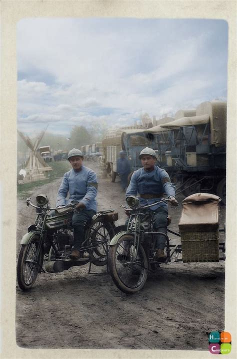 Two Men Riding Motorcycles Down A Dirt Road