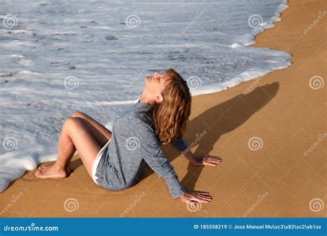 Mature Woman Relaxing At Beach With Eyes Closed High Res Stock Photo