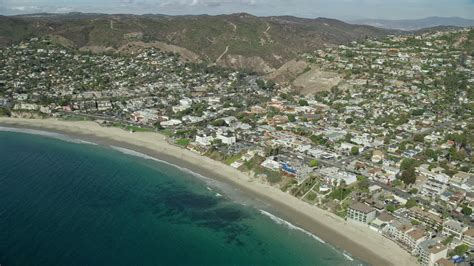 76k Stock Footage Aerial Video Flying Over Ocean Beach And Houses