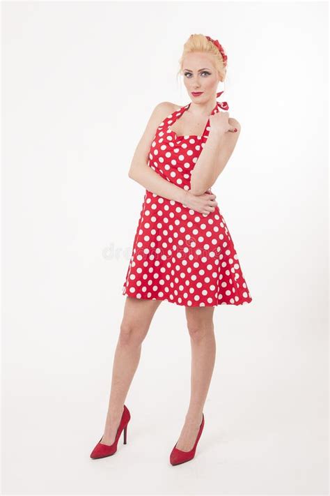 Young Beautiful Caucasian Woman Posing In A Pin Up Red Dress Style
