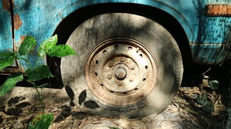 Old Flat Tyre Of Old Blue Vehicle In The Abandoned Place Stock Image