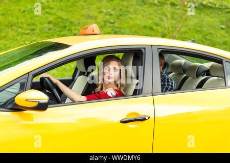 Photo Of Driver And Blonde In Back Seat With Phone In Their Hands
