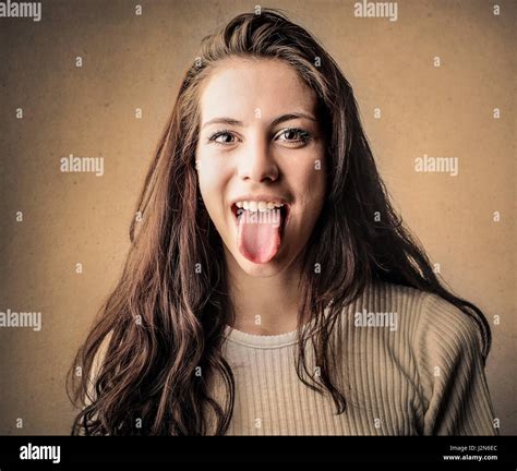 Brunette Woman Sticking Her Tongue Out Stock Photo Alamy