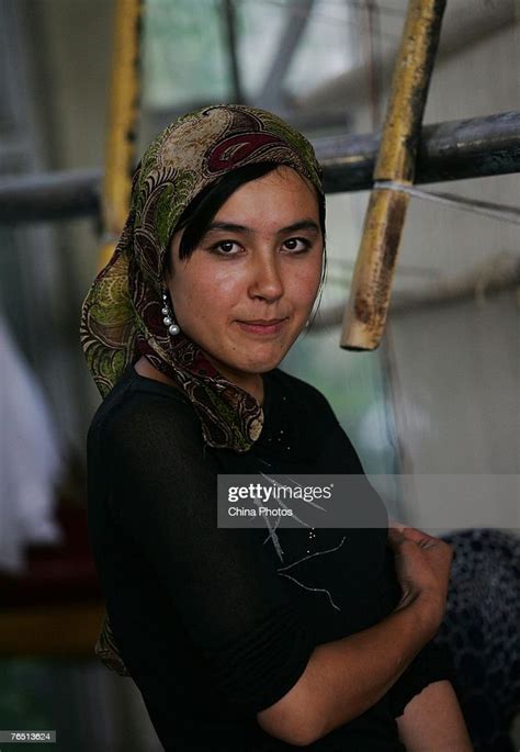 A Uigur Woman Takes A Break Of Weaving A Carpet In The Hetian Carpet