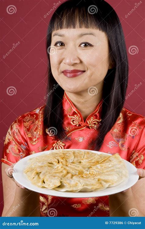 Chinese Woman Holding A Plate Full Of Dumplings Royalty Free Stock