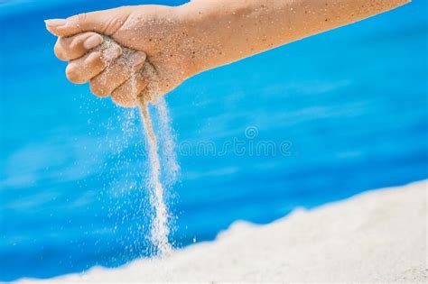 A Hands Pour Sand Off The Sea On Nature On A Journey Vacations At Sea