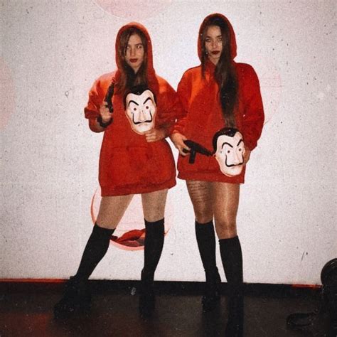 Two Women Dressed In Red Posing For The Camera