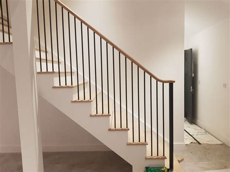 Fitting In Progress For This Staircase Featuring Round Metal Spindles