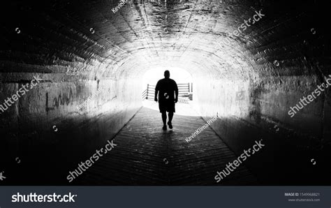 Black Silhouette Walking Through Tunnel Stock Photo Edit Now 1549968821