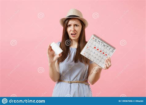 Portrait Of Sad Woman In Blue Dress Holding White Bottle With Pills