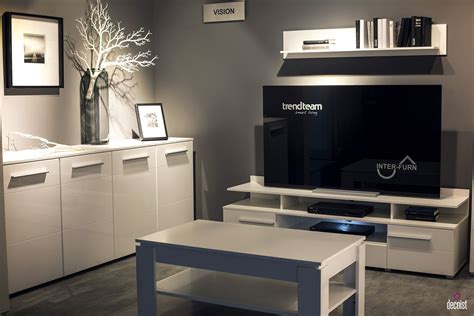 A Living Room With White Furniture And A Large Television On Top Of A