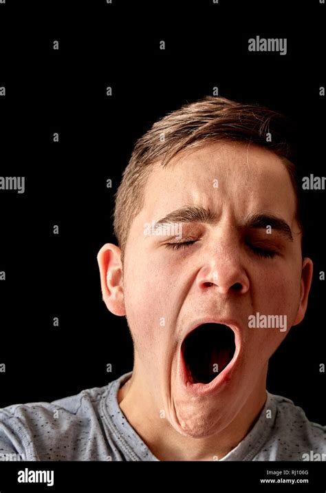 A Bored Male Teenager Yawns With Mouth Wide Open Stock Photo Alamy