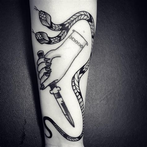What does a snake tattoo symbolize? "Double headed snake around hand with knife by @katie ...