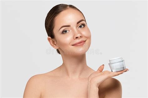 Beautiful Woman With Healthy Smooth Facial Clean Skin Holding Bottle