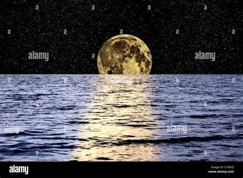 Full Moon Setting Over The Ocean Stock Photo Alamy