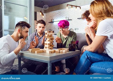 A Cheerful Group Of Friends Play Board Games Stock Photo Image Of