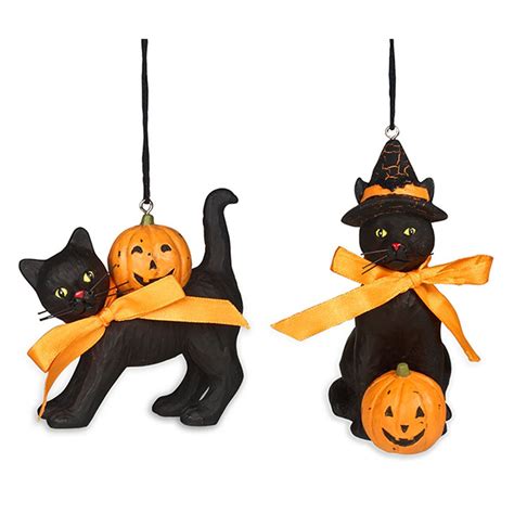 Two Black Cats With Pumpkins Hanging From Strings