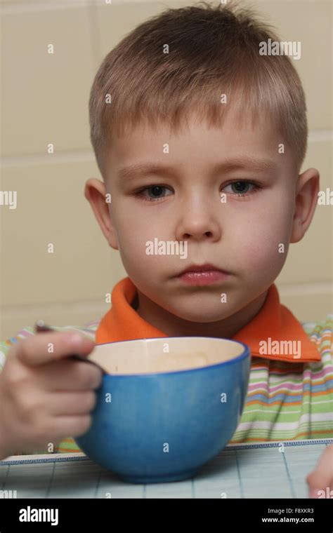 Little Boy At The Dinner Table Stock Photo Alamy