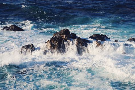 Sea Waves Hitting Rocks In Sea During Daytime By Blake Bronstad Photo