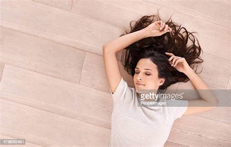 woman sleeping on floor photos and premium high res pictures getty images