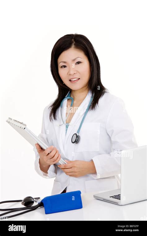 Beautiful Asian Woman Doctor Nurse Working At A Desk Stock Photo Alamy