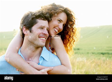 Man Carrying Woman In A Wheat Field Stock Photo Alamy